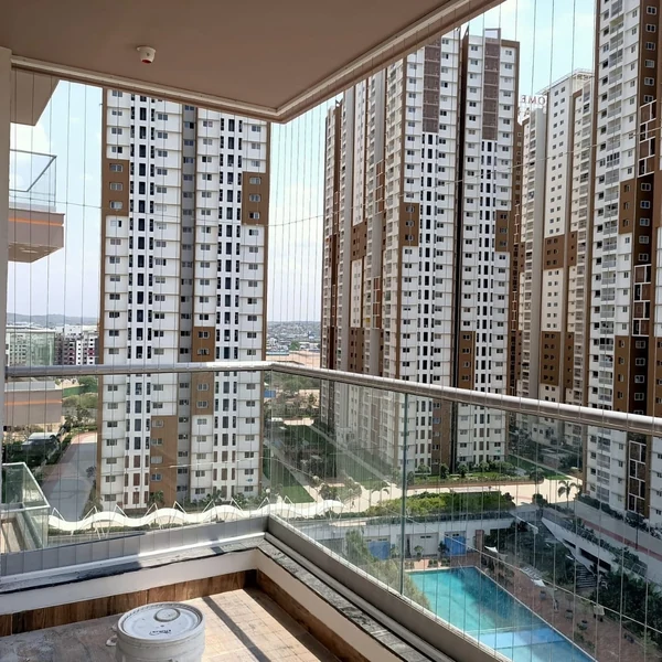 Vertical cables fitted around a corner balcony with a glass railing.