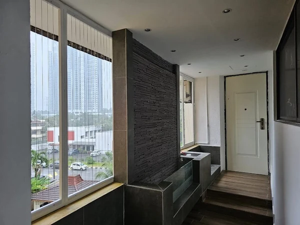 Vertical cables fitted across windows beside an interior walkway.