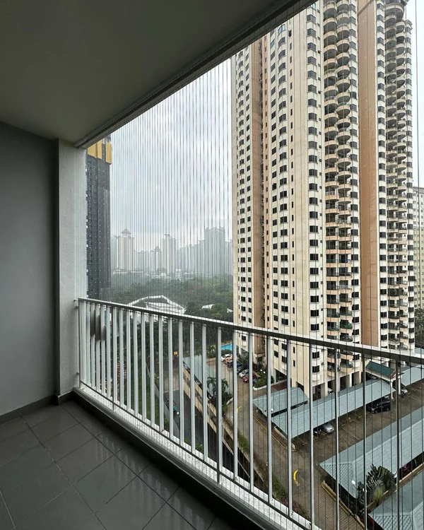 A portrait view of the cable installation above a balcony railing.